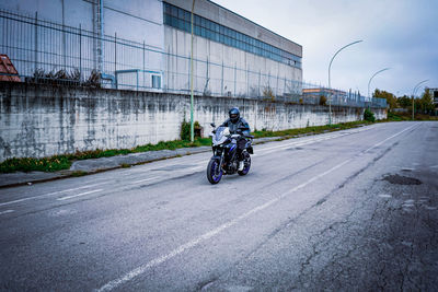 Man riding motorcycle on road