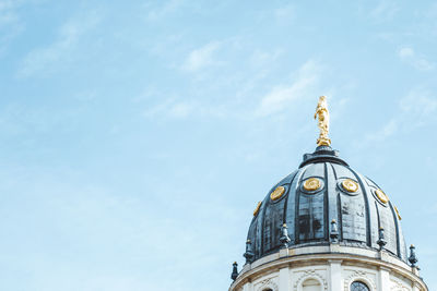 Low angle view of neue kirche against sky in city