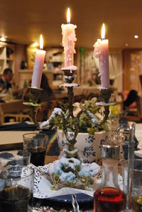 Close-up of illuminated candles on table