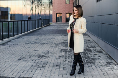 Woman standing on footpath