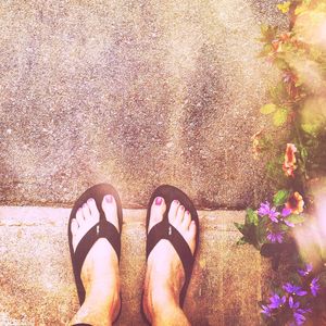 Low section of woman standing on tiled floor