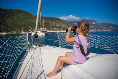 Rear view of woman looking at sea against sky