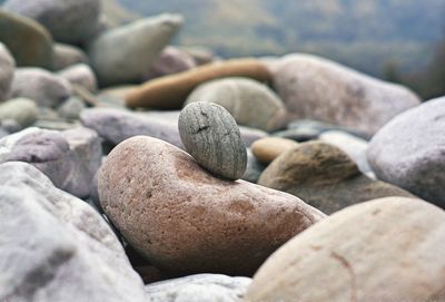 Nature theories, uttarakhand, india- bokeh of weathered pebble stacked by shore