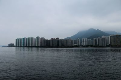 Scenic view of sea and buildings against sky