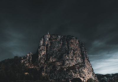 Low angle view of rock formation against sky