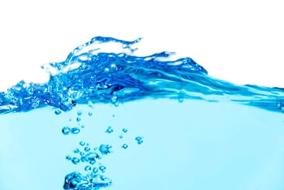 Close-up of bubbles over sea against white background