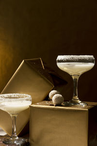 Festive beverages. white coco cocktails glasses on golden background. celebration concept