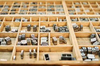 Set of metal shabby letterpress letters placed in wooden box in typography