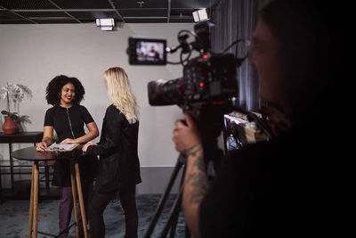 Female news anchors reporting news in studio