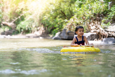 Little girl playing at mountain stream