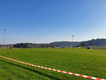Scenic view of field against clear blue sky
