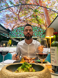 Portrait of man having food in restaurant