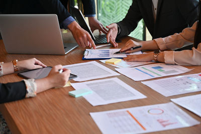 Group of people using laptop on table