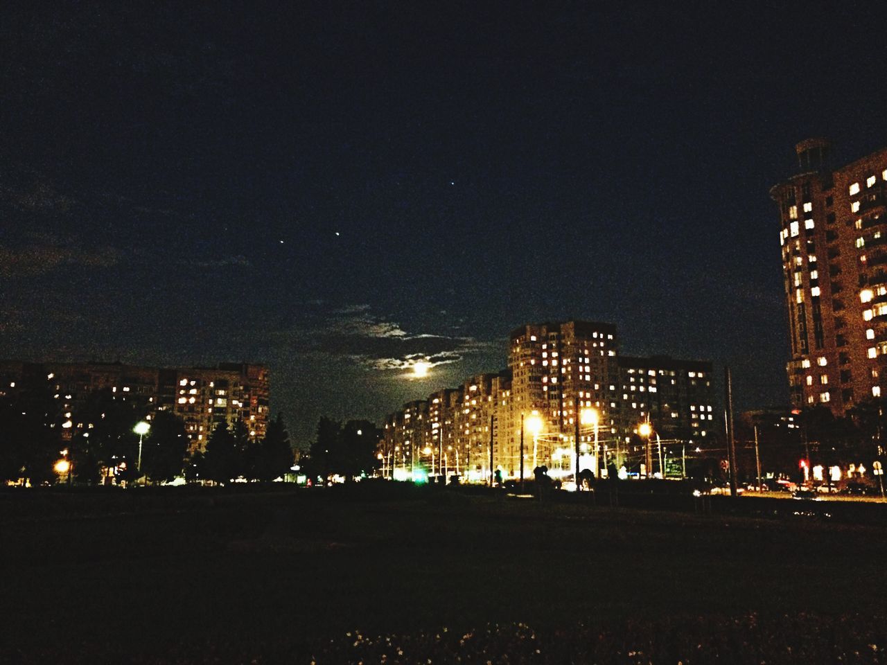 illuminated, night, city, building exterior, architecture, built structure, cityscape, lighting equipment, sky, dark, light - natural phenomenon, city life, street light, glowing, skyscraper, clear sky, copy space, river, outdoors, light