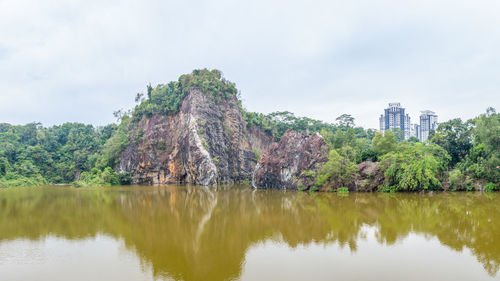 Scenic view of lake by trees against sky