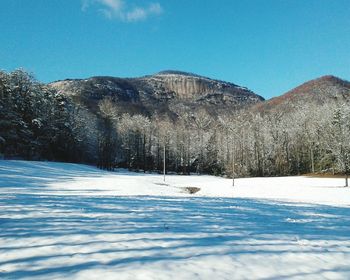 Scenic view of snow covered landscape against clear blue sky