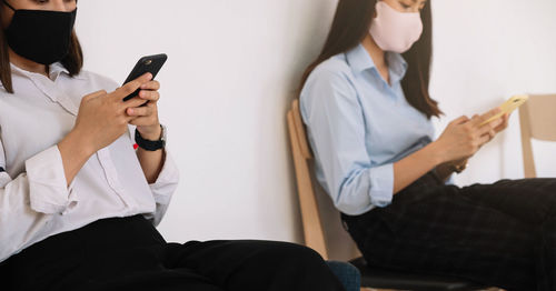 Midsection of man using mobile phone