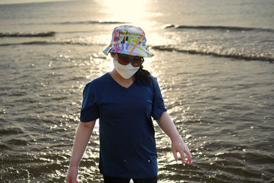 Rear view of man standing at beach