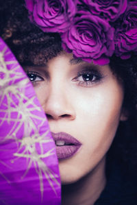 Close-up portrait of woman with pink flowers