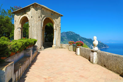 Gazebo by building against clear blue sky