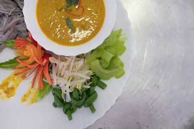 High angle view of chopped fruits in plate on table