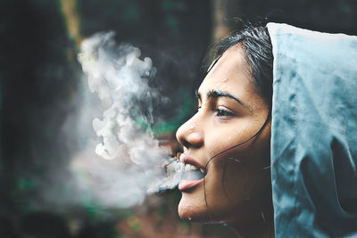 Close-up of woman smoking outdoors