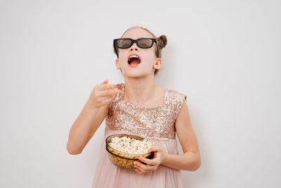 Young woman wearing mask against white background