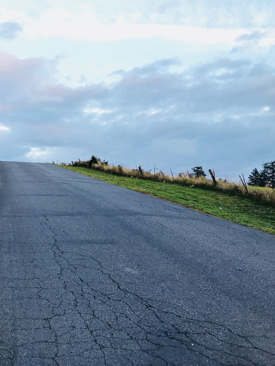 ROAD AMIDST FIELD AND SKY