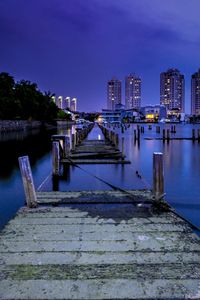 View of bridge over river in city against sky