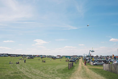 Panoramic view of people in park against sky