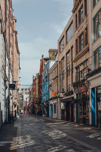 Street amidst buildings in city against sky