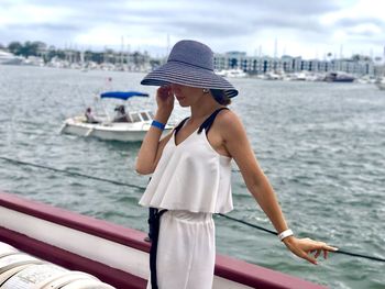 Full length of young woman in boat at sea