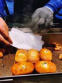 Close-up of hand holding orange food
