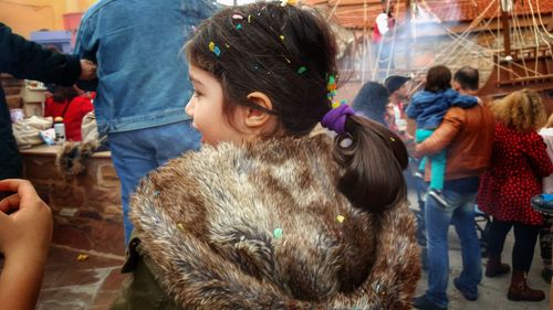 Rear view of girl wearing winter coat in market