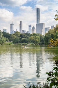 Scenic view of lake by buildings against sky
