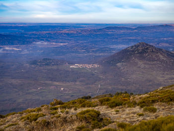 Scenic view of landscape against cloudy sky