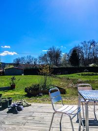 Scenic view of grass and trees against sky