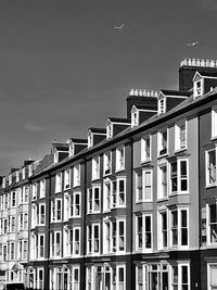 Low angle view of buildings in town against sky