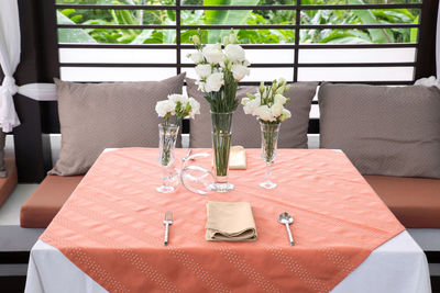 Flower vase on table in restaurant