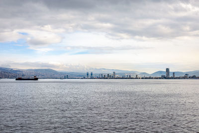 City view of izmir from the ferryboat. cold grey winter aegean sea.