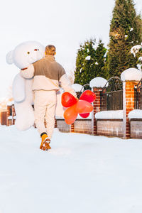Man behind teddy bear gift heart air romantic surprise birthday, christmas, valentine's day women's 