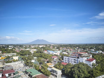 High angle view of town by sea against sky