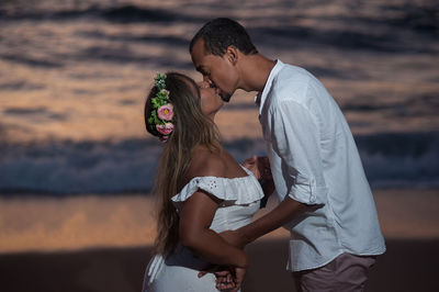 Rear view of couple holding hands