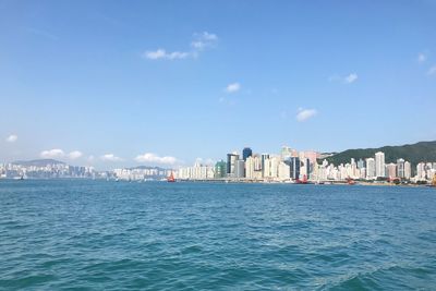 View of sea against buildings in city