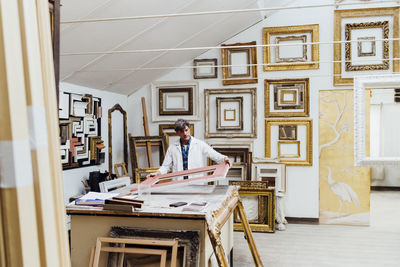 Carpenter making frames in workshop