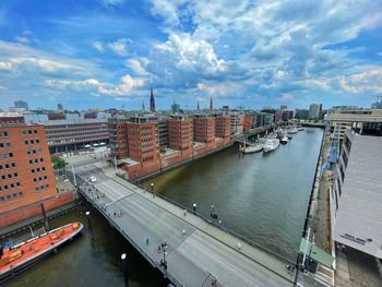 High angle view of bridge over river in city against sky