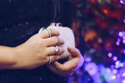 Cropped image of woman holding sunglasses