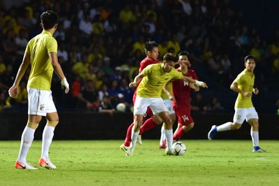 Group of people playing soccer on field