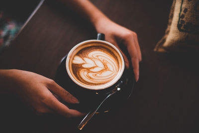 Close-up of woman holding coffee