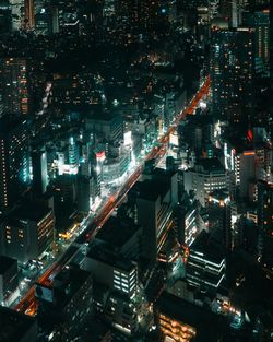 High angle view of illuminated city buildings at night